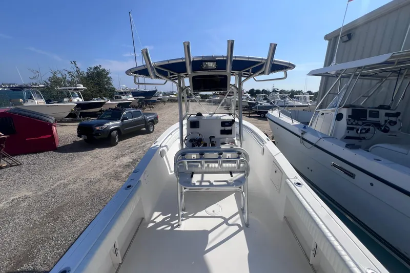 Slide: The Image of 2007 Sea Hunt Triton 240 boat in a marina, surrounded by other vessels. - 11