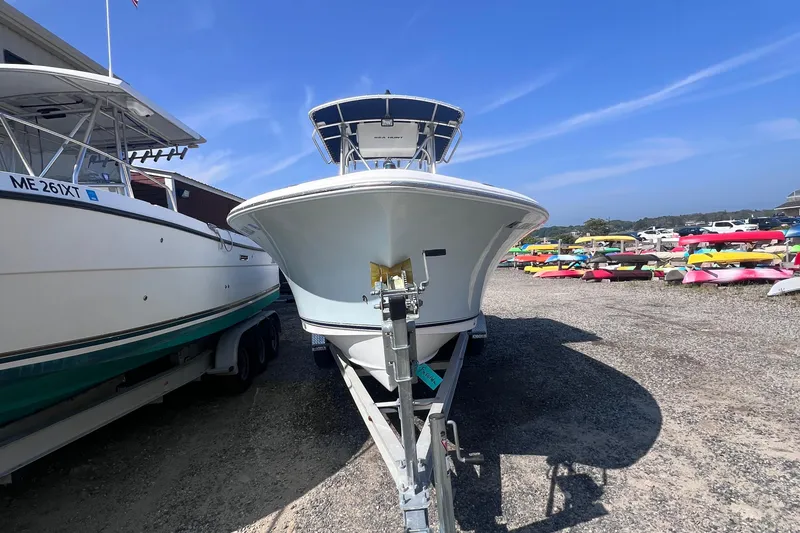 Slide: The Image of 2007 Sea Hunt Triton 240 boat on trailer in sunny outdoor storage area. - 2