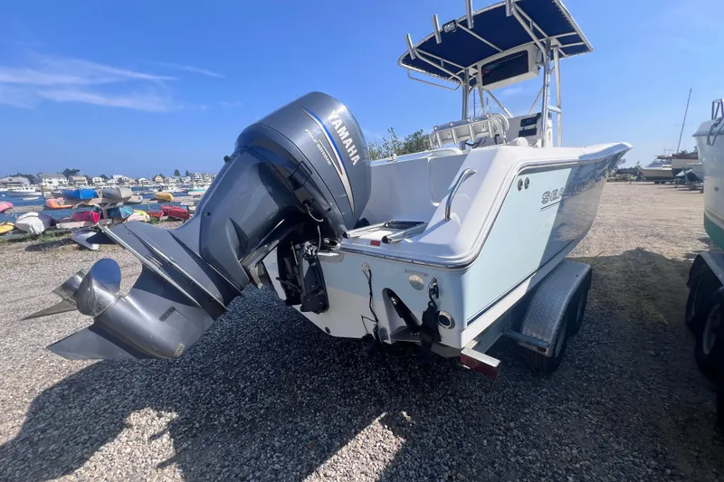 Slide: The Image of 2007 Sea Hunt Triton 240 boat with Yamaha outboard motor on a trailer. - 3