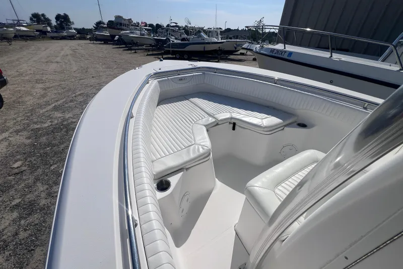 Slide: The Image of 2007 Sea Hunt Triton 240 boat with white seating, docked in a marina. - 6
