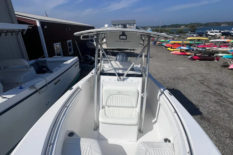 Slide: The Image of 2007 Sea Hunt Triton 240 boat docked, showcasing sleek design and spacious seating. - 9