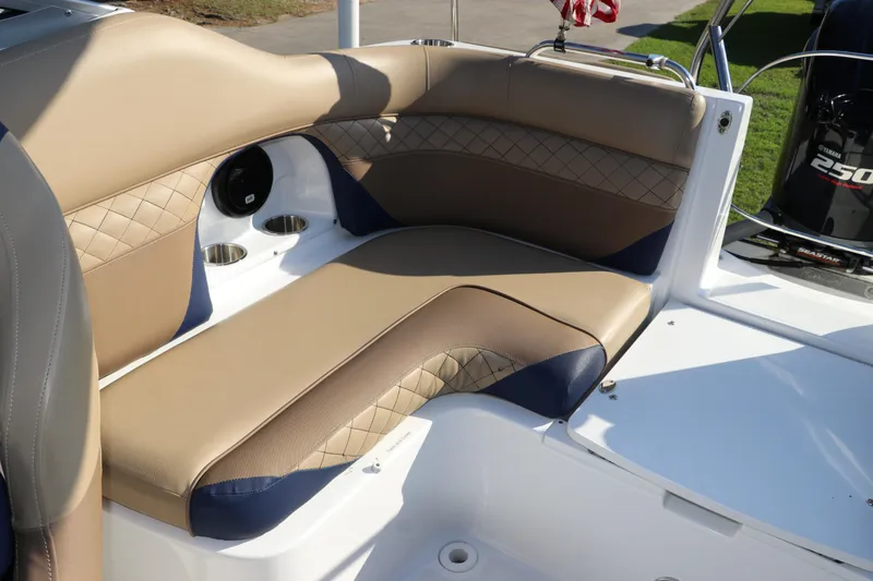Slide: The Image of 2019 Hurricane SunDeck 2486 OB boat interior with tan and blue seating. - 13