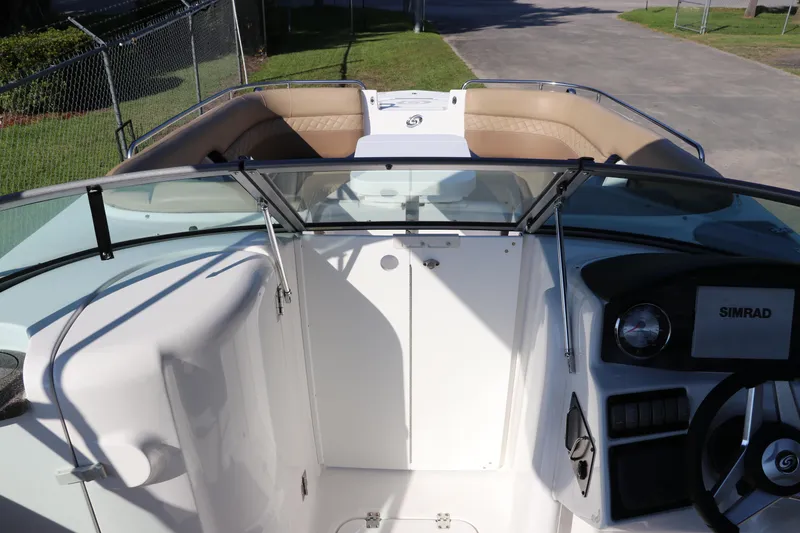 Slide: The Image of 2019 Hurricane SunDeck 2486 OB boat interior with seating and control panel. - 17