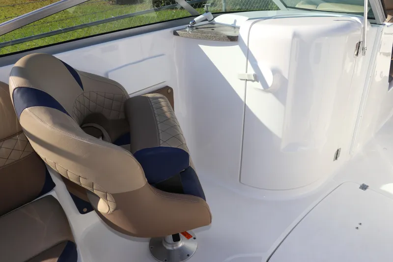 Slide: The Image of 2019 Hurricane SunDeck 2486 OB boat interior with cushioned seating and sleek design. - 23