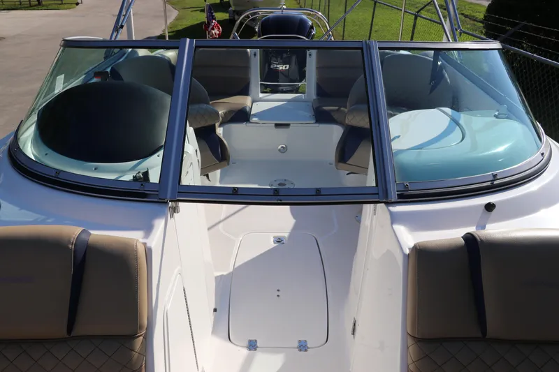 Slide: The Image of 2019 Hurricane SunDeck 2486 OB boat interior with seating and windshield. - 24