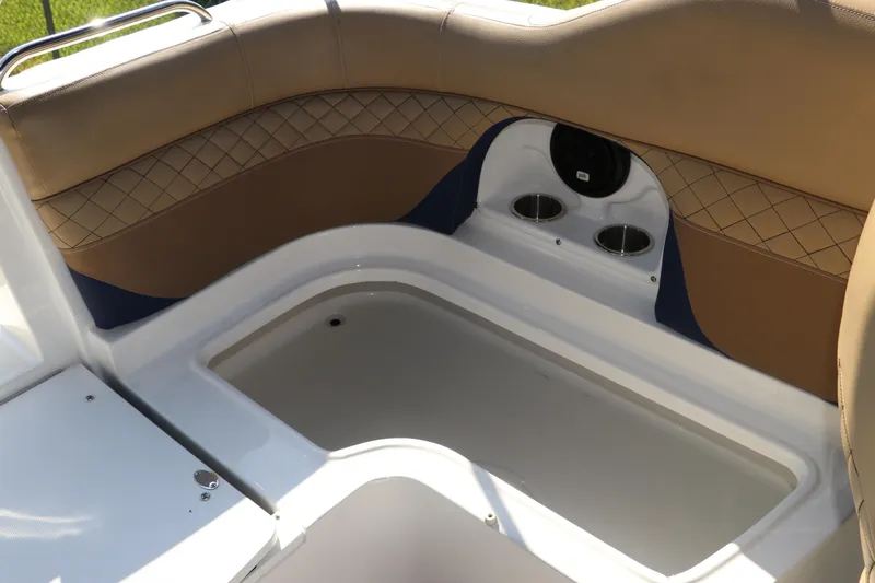 Slide: The Image of 2019 Hurricane SunDeck 2486 OB boat interior with cushioned seating and storage compartment. - 30