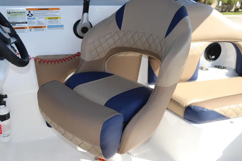 Slide: The Image of Captain's seat on 2019 Hurricane SunDeck 2486 OB boat, featuring beige and blue upholstery. - 34