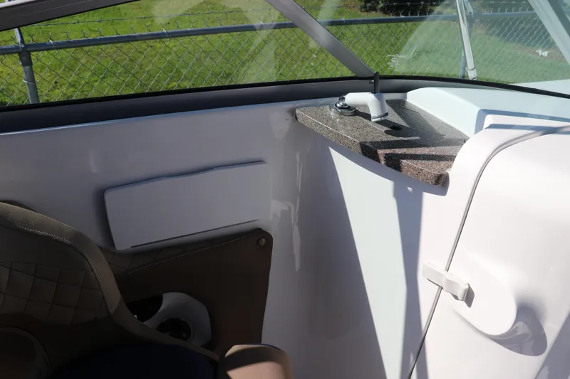 Slide: The Image of 2019 Hurricane SunDeck 2486 OB interior with seating and console details. - 39