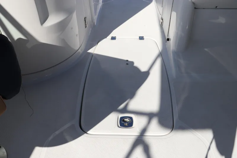 Slide: The Image of 2019 Hurricane SunDeck 2486 OB boat deck with storage hatch and shadows. - 46