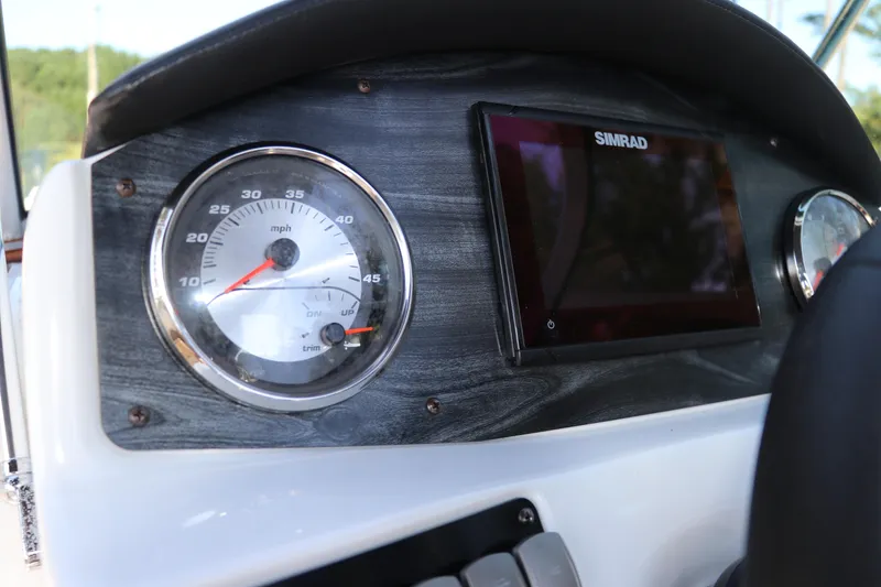 Slide: The Image of Dashboard of 2019 Hurricane SunDeck 2486 OB with speedometer and Simrad display. - 48