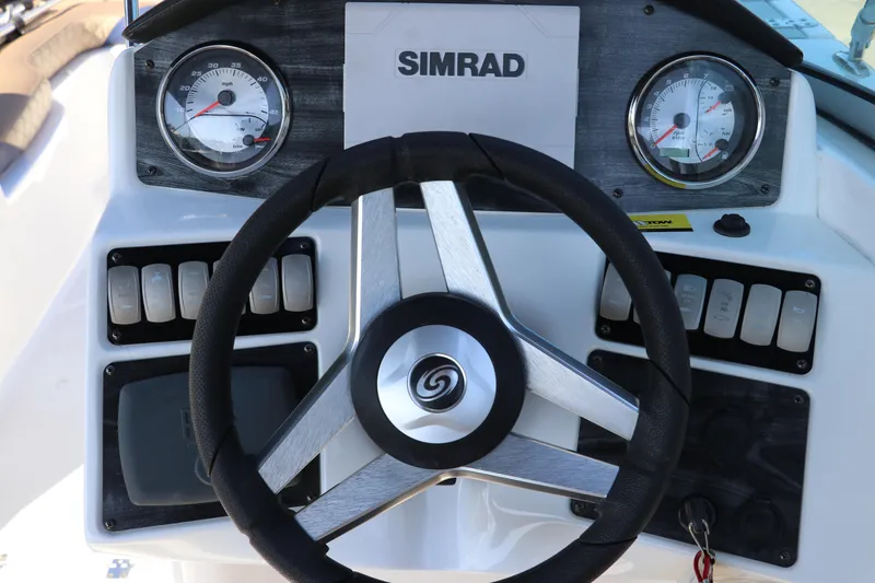 Slide: The Image of 2019 Hurricane SunDeck 2486 OB boat dashboard with steering wheel and gauges. - 52