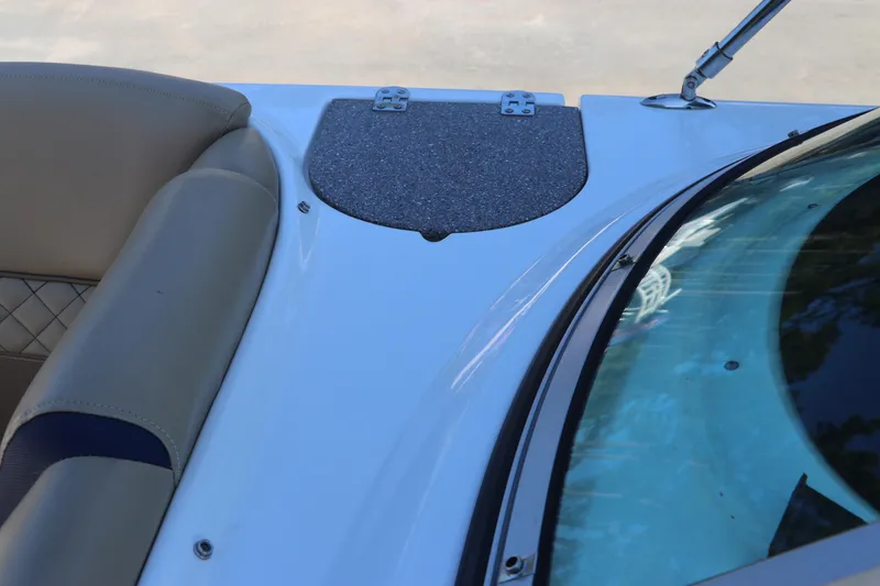 Slide: The Image of 2019 Hurricane SunDeck 2486 OB boat interior with beige seating and windshield detail. - 59