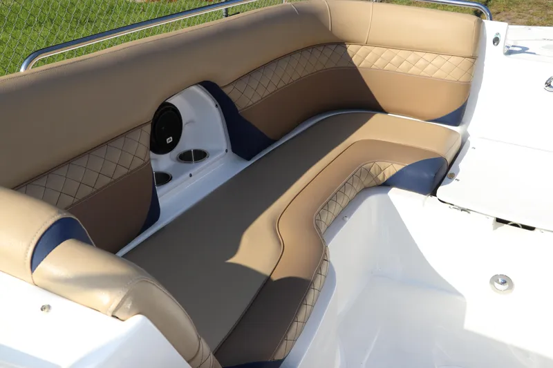 Slide: The Image of 2019 Hurricane SunDeck 2486 OB boat interior with tan and blue cushioned seating. - 61
