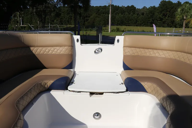 Slide: The Image of 2019 Hurricane SunDeck 2486 OB boat interior with tan and blue seating. - 65