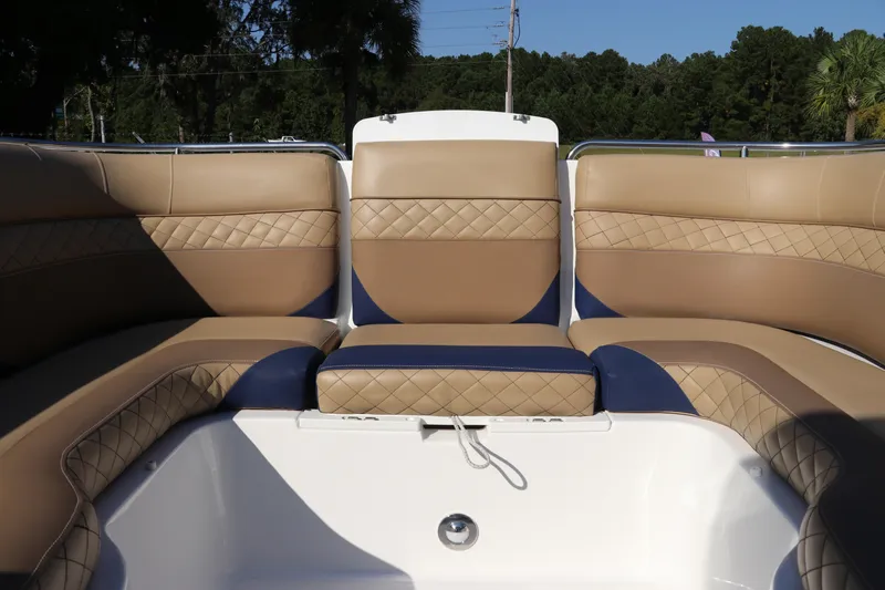 Slide: The Image of 2019 Hurricane SunDeck 2486 OB boat interior with tan and blue cushioned seating. - 66