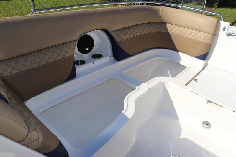 Slide: The Image of 2019 Hurricane SunDeck 2486 OB boat interior with cushioned seating and storage compartments. - 67
