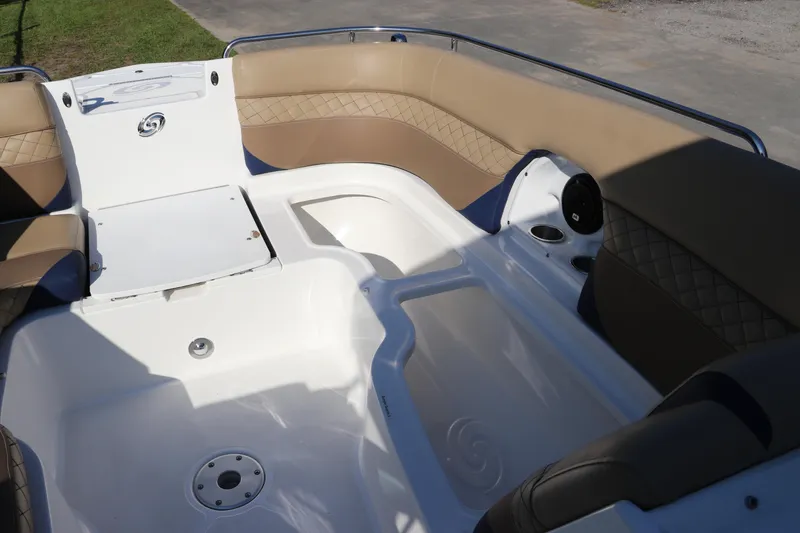 Slide: The Image of 2019 Hurricane SunDeck 2486 OB boat interior with tan seating and storage compartments. - 68