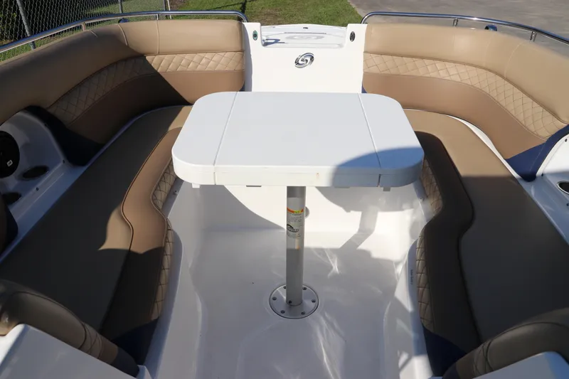 Slide: The Image of 2019 Hurricane SunDeck 2486 OB boat interior with cushioned seating and table. - 70