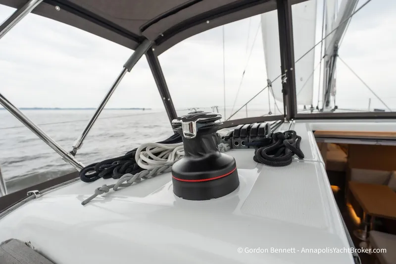 Slide: The Image of 2022 Jeanneau Sun Odyssey 410 sailboat deck with winch and ropes, sailing on open water. - 17