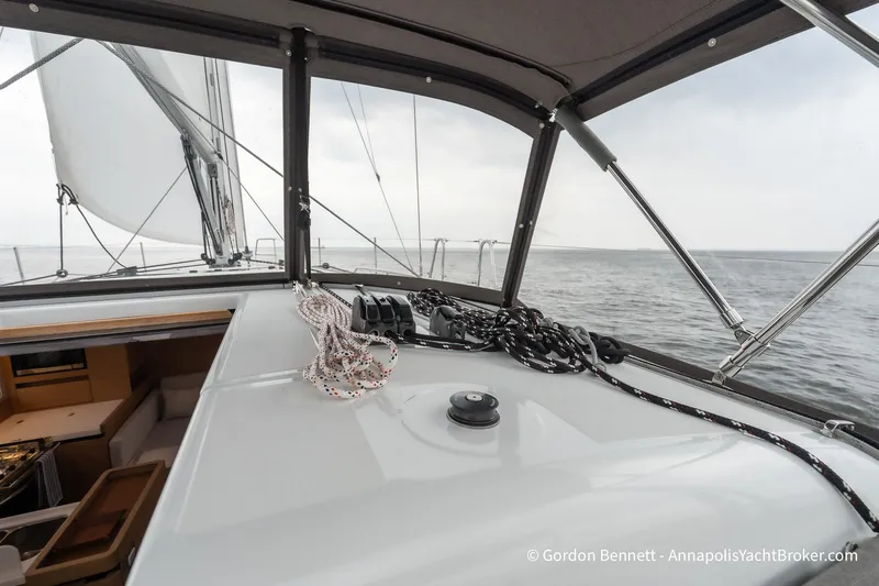 Slide: The Image of Jeanneau Sun Odyssey 410 sailing yacht cockpit view, showcasing ropes and open sea. - 18