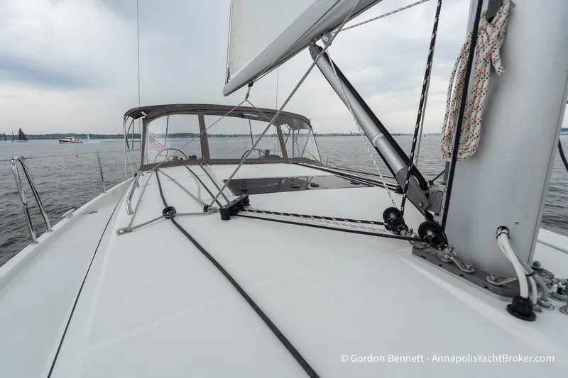 Slide: The Image of 2022 Jeanneau Sun Odyssey 410 sailboat deck with rigging on calm waters. - 23