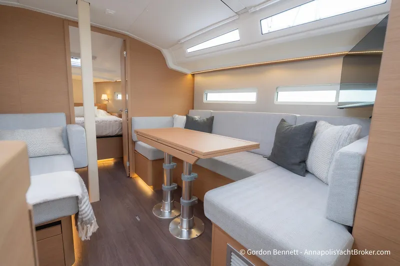 Slide: The Image of Luxurious interior of 2022 Jeanneau Sun Odyssey 410 yacht with modern seating and dining area. - 31