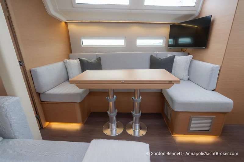 Slide: The Image of Interior of 2022 Jeanneau Sun Odyssey 410 yacht with modern seating and table. - 32