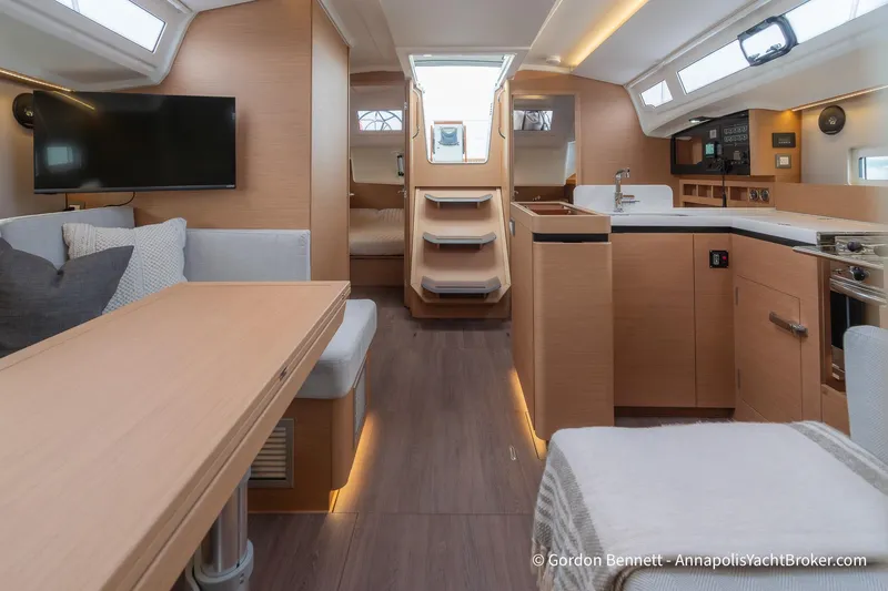 Slide: The Image of Interior of 2022 Jeanneau Sun Odyssey 410 yacht, featuring modern kitchen and cozy seating area. - 40