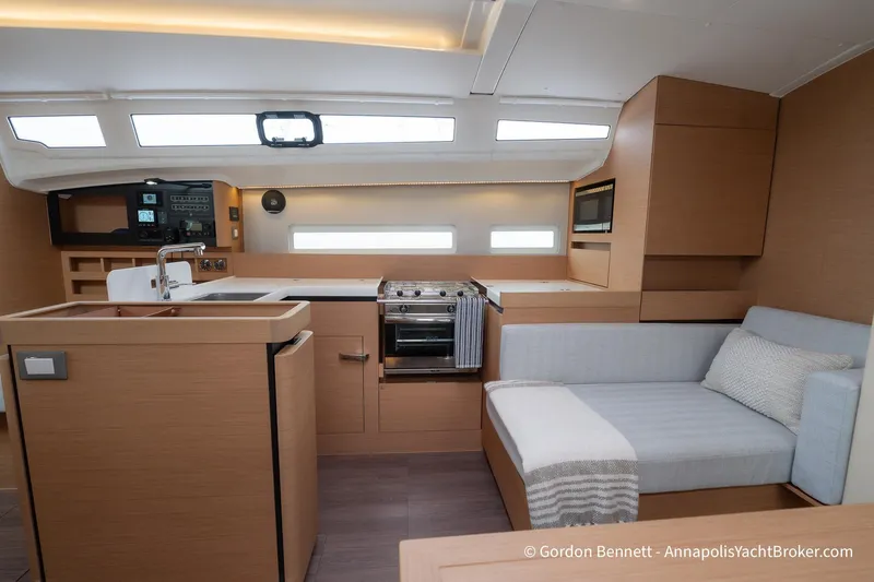 Slide: The Image of Modern interior of 2022 Jeanneau Sun Odyssey 410 yacht with kitchen and seating area. - 41
