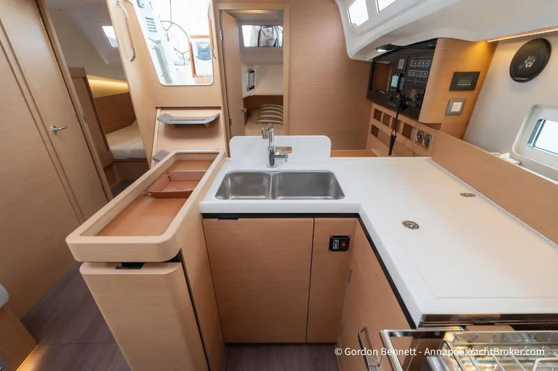 Slide: The Image of Modern kitchen interior of 2022 Jeanneau Sun Odyssey 410 yacht, featuring sleek cabinetry and dual sinks. - 43