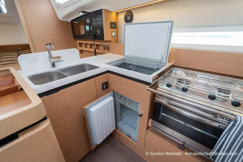 Slide: The Image of Modern kitchen in 2022 Jeanneau Sun Odyssey 410 yacht with stove, sink, and fridge. - 44