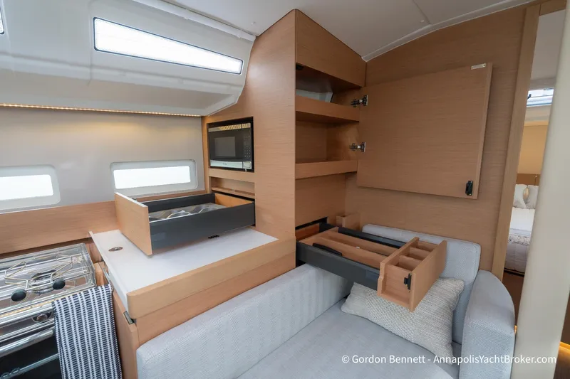 Slide: The Image of Interior of 2022 Jeanneau Sun Odyssey 410 yacht with modern kitchen and storage. - 46