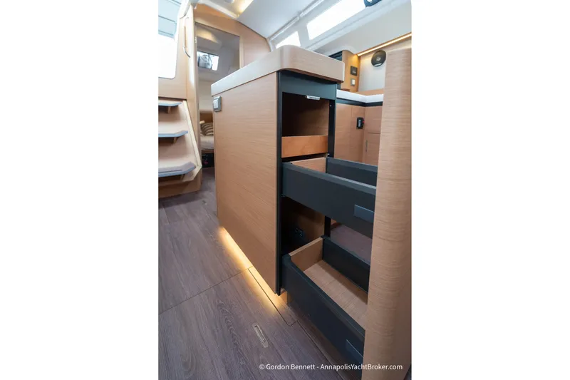 Slide: The Image of Interior of 2022 Jeanneau Sun Odyssey 410 yacht with open storage drawers. - 47