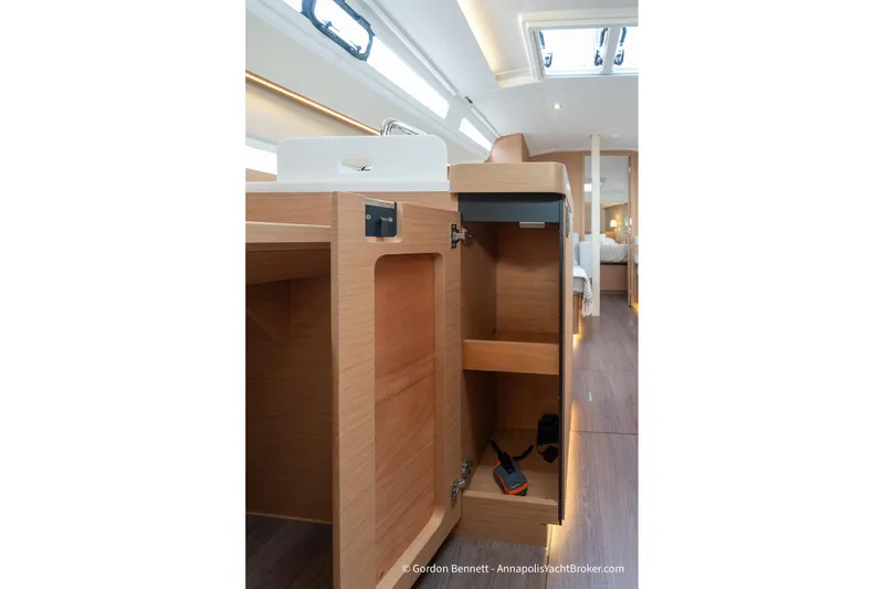 Slide: The Image of Interior view of 2022 Jeanneau Sun Odyssey 410 yacht, featuring open wooden cabinetry. - 48