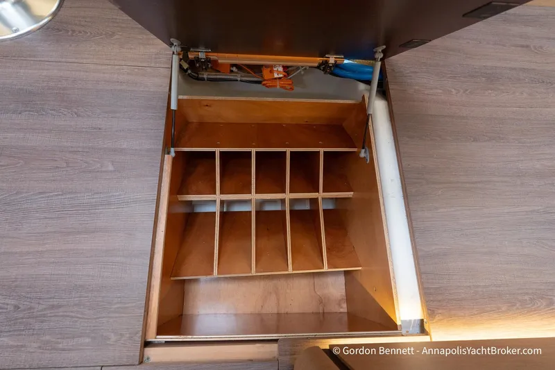 Slide: The Image of Open storage compartment on Jeanneau Sun Odyssey 410 yacht, 2022 model, with wooden dividers. - 49