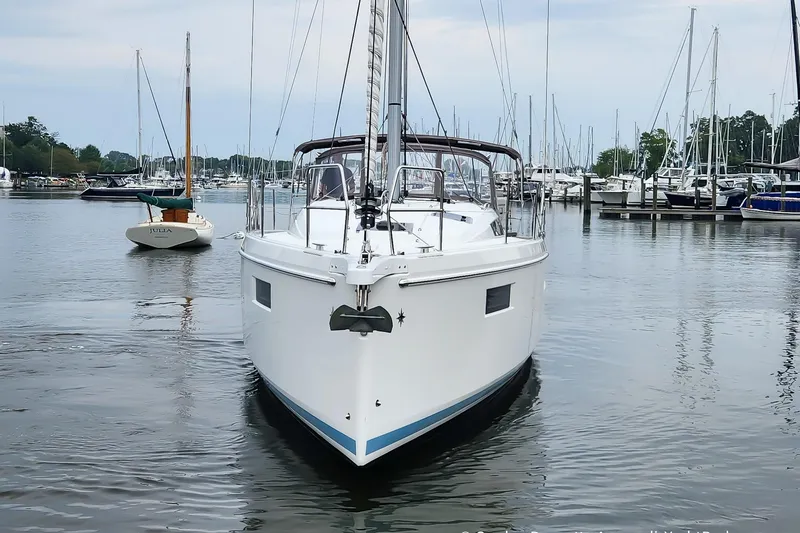 Slide: The Image of 2022 Jeanneau Sun Odyssey 410 sailboat docked in a marina, surrounded by other boats. - 5