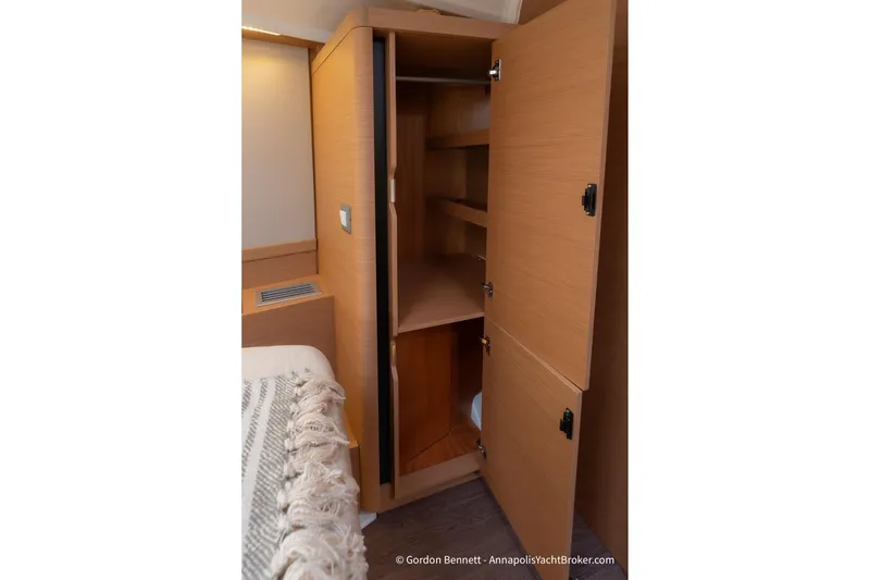 Slide: The Image of Interior view of Jeanneau Sun Odyssey 410, 2022 model, featuring a wooden storage cabinet. - 54