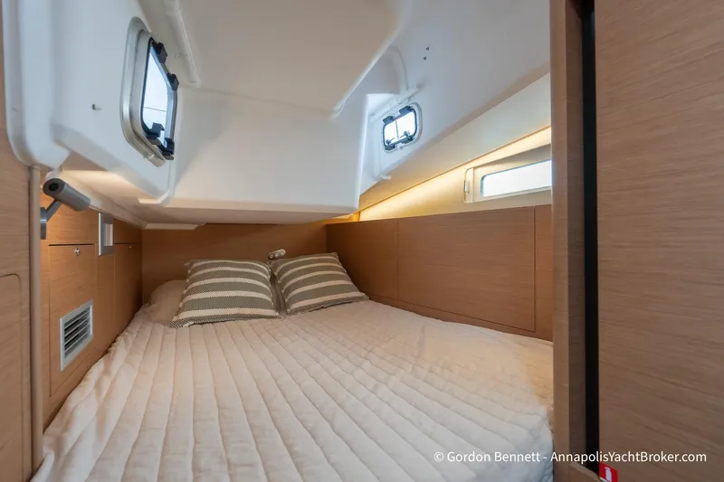 Slide: The Image of Cozy cabin interior of 2022 Jeanneau Sun Odyssey 410 yacht with striped pillows. - 57