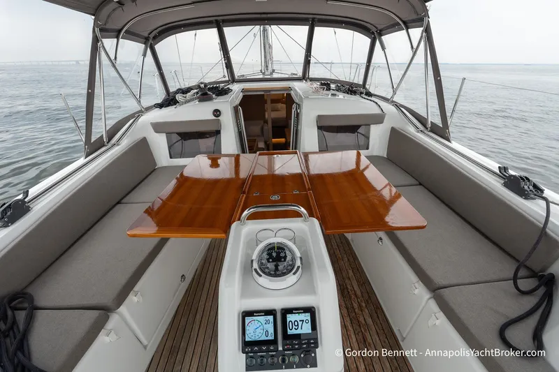 Slide: The Image of 2022 Jeanneau Sun Odyssey 410 cockpit with wooden table and navigation instruments. - 6