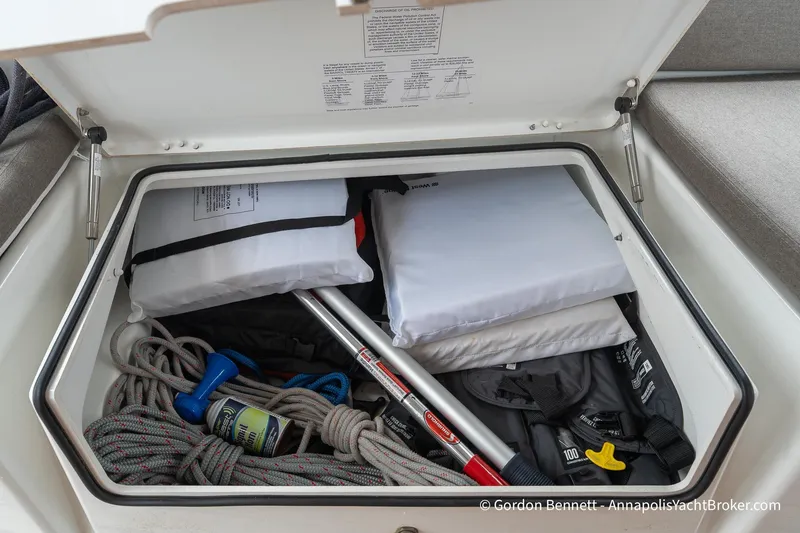 Slide: The Image of Storage compartment on a 2022 Jeanneau Sun Odyssey 410 yacht, containing ropes and safety equipment. - 64