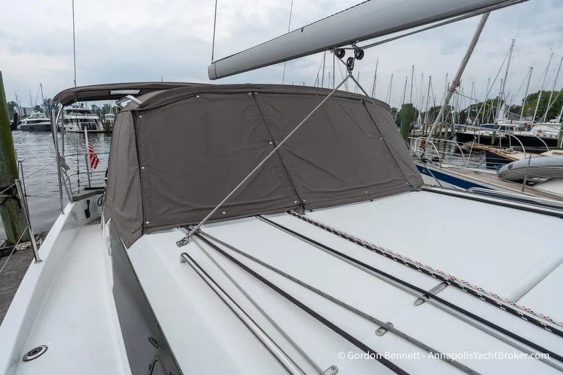 Slide: The Image of 2022 Jeanneau Sun Odyssey 410 sailboat docked, featuring covered cockpit and sleek design. - 68