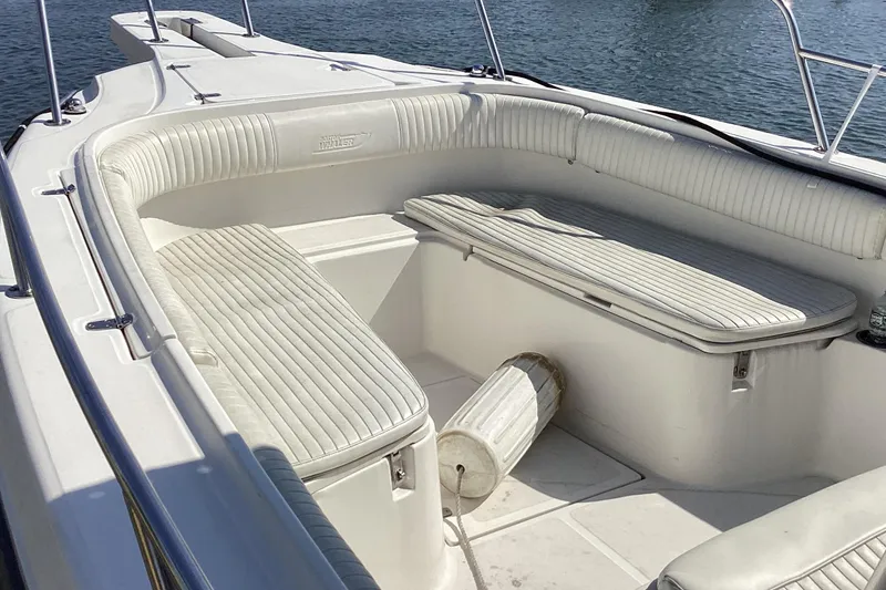 Slide: The Image of 2001 Boston Whaler 260 Outrage boat interior with white cushioned seating. - 10
