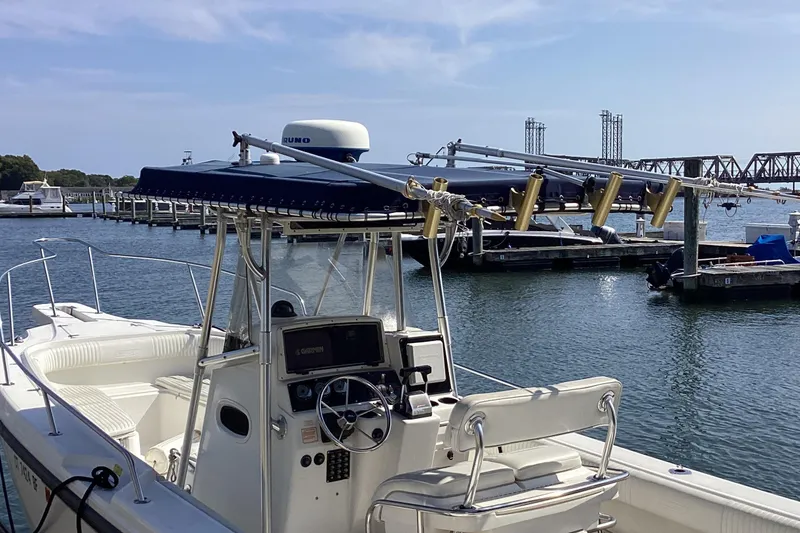 Slide: The Image of 2001 Boston Whaler 260 Outrage boat docked at marina, featuring navigation equipment. - 22