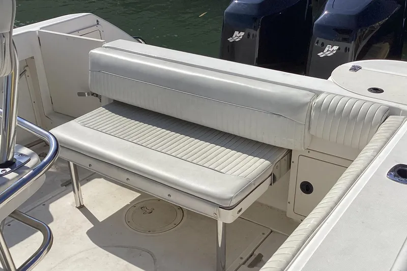 Slide: The Image of Boston Whaler 260 Outrage 2001 boat interior with cushioned seating and dual engines. - 6