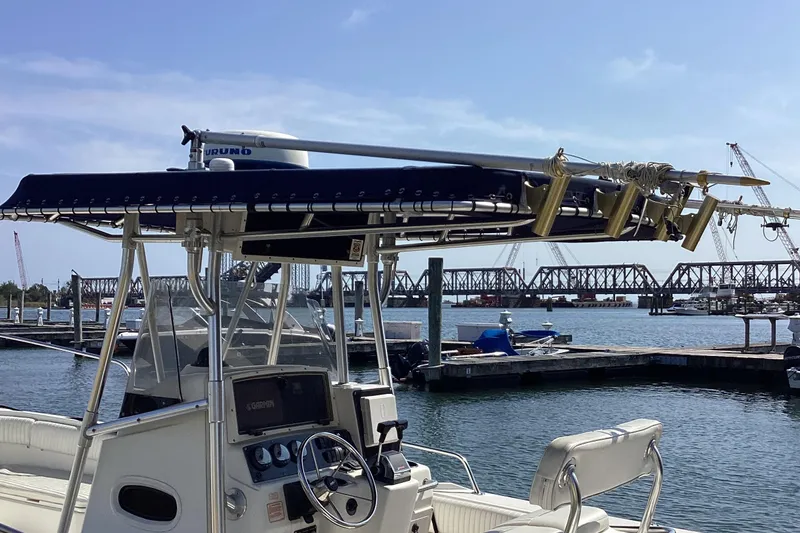 Slide: The Image of 2001 Boston Whaler 260 Outrage boat docked at marina with bridge in background. - 9