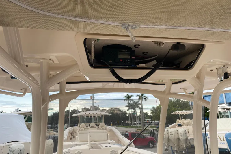 Slide: The Image of 2018 Grady-White Canyon 306 boat interior with electronic equipment and overhead storage. - 10