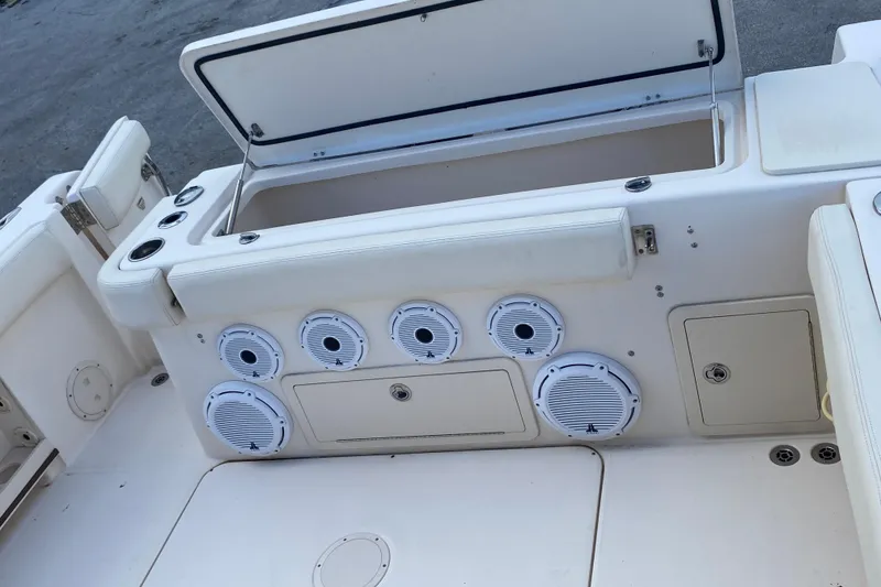 Slide: The Image of 2018 Grady-White Canyon 306 boat interior with storage compartments and speakers. - 14
