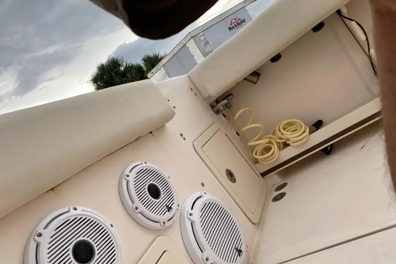 Slide: The Image of 2018 Grady-White Canyon 306 boat interior with speakers and coiled hose. - 15