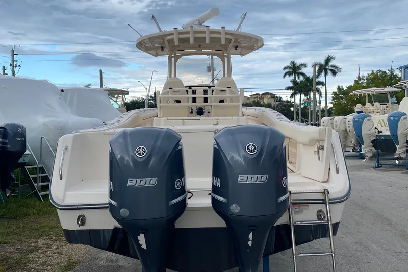 Slide: The Image of 2018 Grady-White Canyon 306 boat with twin Yamaha 300 engines, docked outdoors. - 17