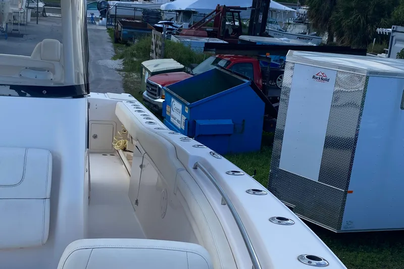 Slide: The Image of 2018 Grady-White Canyon 306 boat docked near trailers and equipment. - 4